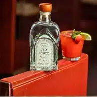 Home 9 Bottle of Casa Mexico Blanco Tequila next to a cocktail